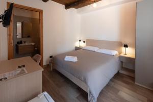 a bedroom with a white bed and a bathroom at Wake&Relax in Decollatura
