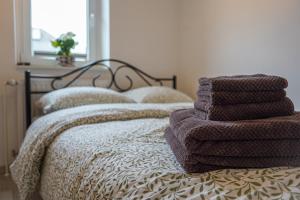 a pile of towels sitting on top of a bed at Bloom Residence Gomzi in Naklo