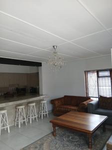 a living room with a couch and a table at Abebe Guest House in George +14 photos