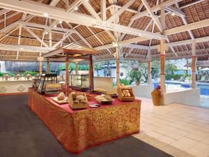 a resort lobby with a table with pillows on it at Mercure Resort Sanur in Sanur