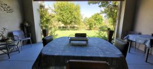 a room with a table with a suitcase on top of it at Ouma Bettie Guesthouse in Piketberg +12 photos
