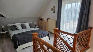 a bedroom with a bed and a large window at Sunlight Apartmanház in Velence