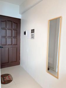 a bathroom with a mirror and a door at Royal Oceancrest Panglao 1020 in Dao