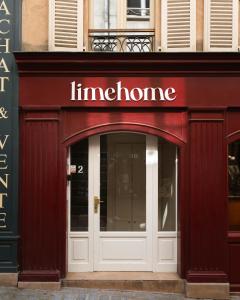 a entrance to a store with a sign over the door at Limehome Versailles Rue du Bailliage in Versailles