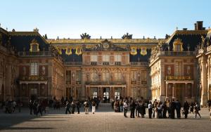 a group of people standing in front of a large building at Limehome Versailles Rue du Bailliage in Versailles