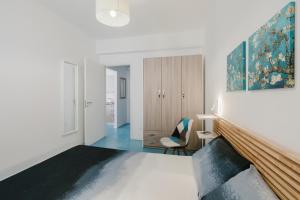 a living room with white walls and blue flooring at Orizzonte Blu apartment - Macari Bay in Macari +57 photos