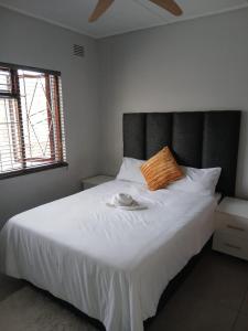 a bedroom with a bed with a plate on it at Abebe Guest House in George
