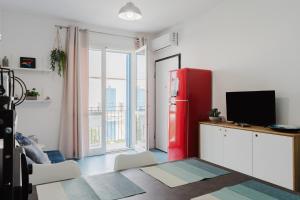 a red refrigerator in a room with a window at Orizzonte Blu apartment - Macari Bay in Macari