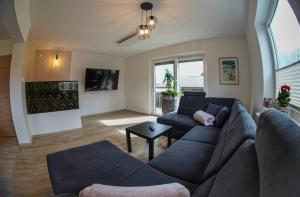 a living room with a couch and a table at Bloom Residence Gomzi in Naklo