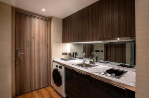 a kitchen with a sink and a washing machine at Nish Palace Beşiktaş in Istanbul +104 photos