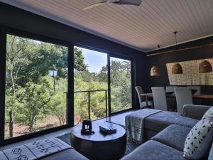 a living room with a couch and a table at Akasha by Kruger Nights in Marloth Park