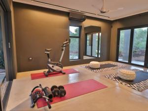 a room with a gym with exercise equipment on the floor at Akasha by Kruger Nights in Marloth Park