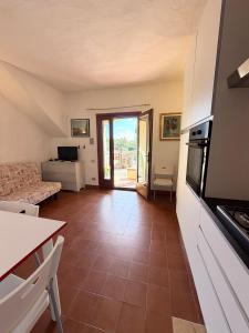 a living room with a couch and a table at Bilocali Ibiscus - 700mt dalla spiaggia in Porto Ottiolu