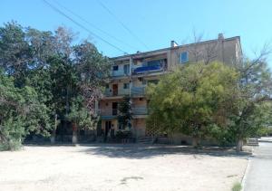 an apartment building with trees in front of it at Апартаменты 3а in Aktau