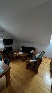 a living room with couches and a table at Apartament D&D in Gorlice
