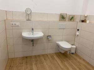 a bathroom with a sink and a toilet at Deck in Cuxhaven