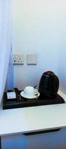 a table with a tea kettle and a plate on it at Bonds Hotel in Nairobi