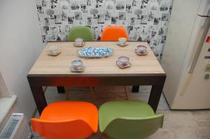 a table and four chairs with bowls and cups on it at Green Apple Hostel in Kyiv