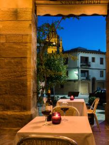 a table with two glasses of wine on a patio at Hospederia de Loarre in Loarre +50 photos