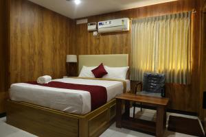 a bedroom with a large bed and a table at SVS Grand in Dindigul +59 photos