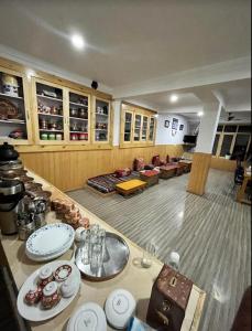 a living room with a table with dishes on it at AO Guest House in Nubra