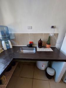 a kitchen counter with a sink and a toilet at Dúplex céntrico LAS SOFIAS - PURMAMARCA in Purmamarca +27 photos