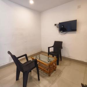 a living room with two chairs and a coffee table at SIYA International Lodging And Boarding in Bhiwandi