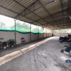 an empty garage with a motorcycle parked in it at SIYA International Lodging And Boarding in Bhiwandi