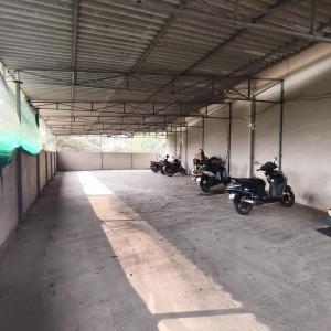 a group of motorcycles parked in a parking garage at SIYA International Lodging And Boarding in Bhiwandi +8 photos