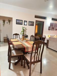 a dining room table and chairs in a room at J kutir in Siliguri