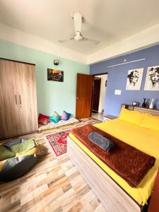 a bedroom with a large yellow bed in a room at J kutir in Siliguri