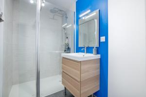 a bathroom with a sink and a shower at L'Echappée Choletaise, simple et familiale! in Cholet +15 photos