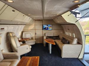 an interior view of an rv with couches and tables at Aerotel in Hoedspruit