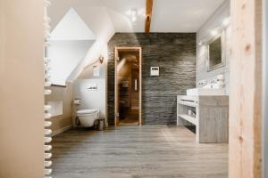 a bathroom with a toilet and a sink at StrandBerg's Stadt Chalet in Braunlage +162 photos
