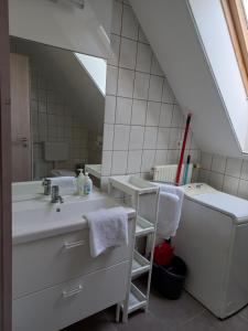 a bathroom with a sink and a mirror at Sunlight Apartmanház in Velence +30 photos