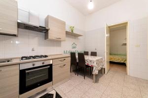 a kitchen with a table with chairs and a dining room at La Dimora del Centro - San Foca in San Foca