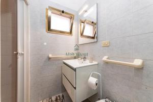 a bathroom with a sink and a mirror and a toilet at La Dimora del Centro - San Foca in San Foca +15 photos