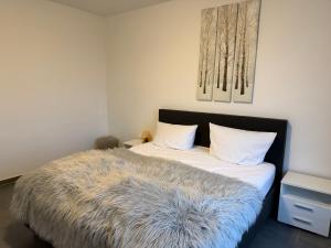 a bedroom with a bed with a furry blanket on it at Deck in Cuxhaven