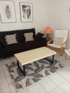 a living room with a couch and a coffee table at Villa Flor by 3VILLAS in Cala en Bosc