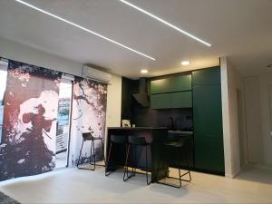 a kitchen with a counter and stools in a room at Apartment Bogunovic in Bar
