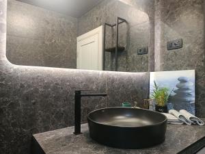 a bathroom with a black sink and a mirror at Apartment Bogunovic in Bar +19 photos