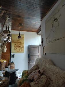 a living room with a couch and a painting on the wall at Edward Lear - Heritage Guest House in Berat