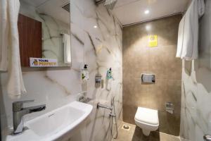 a bathroom with a sink and a toilet at Glitz Rexton Inn - Near IIT Powai in Mumbai