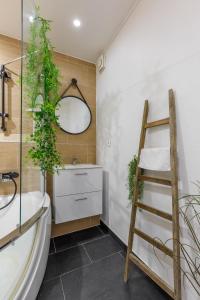 a bathroom with a ladder and a sink and a mirror at Nid Amour Cabane et Spa Privatif in Rouen