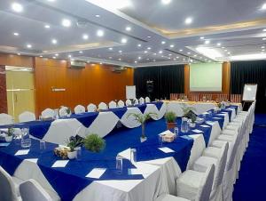 a large banquet hall with blue and white tables and chairs at Days Hotel, Baridhara in Dhaka