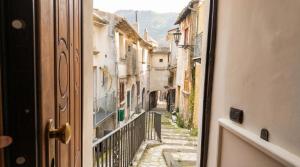 a view of an alley from an open door at Casa Ereva in Bagnoli Irpino