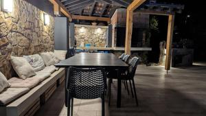 a table and chairs in a patio with a couch at Apartments Tea Pag in Pag