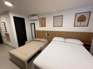 a room with two beds and a bed sidx sidx sidx sidx at Flat Praia Ponta de Campina in Cabedelo +19 photos
