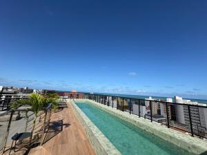 a swimming pool on the roof of a building at Flat Praia Ponta de Campina in Cabedelo