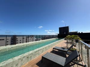 a swimming pool on the roof of a building at Flat Praia Ponta de Campina in Cabedelo